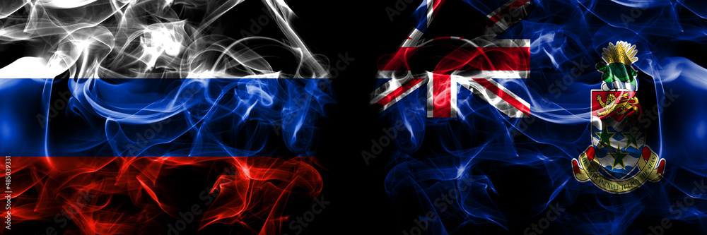 Russia, Russian vs British, Britain, Cayman Islands flags. Smoke flag placed side by side isolated on black background