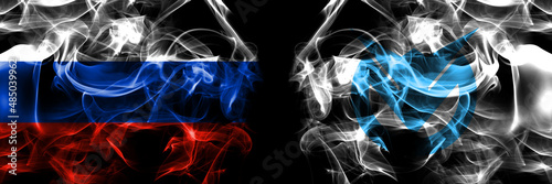 Russia, Russian vs Japan, Japanese, Furubira, Hokkaido, Shiribeshi, Subprefecture flags. Smoke flag placed side by side isolated on black background photo