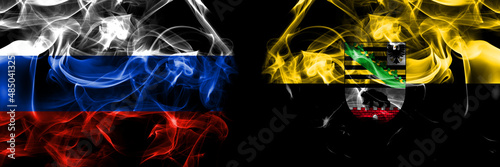 Russia, Russian vs Saxony Anhalt, state flags. Smoke flag placed side by side isolated on black background