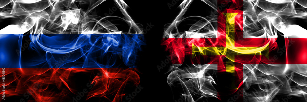 Russia, Russian vs United Kingdom, Great Britain, British, Guernsey  flags. Smoke flag placed side by side isolated on black background