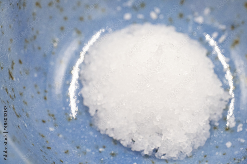Coarse salt in the form of a mountain on a plate. Coarse salt in the form of a mountain on a plate.