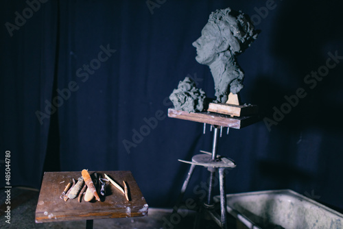 Tools sculptor for create sculpt bust clay human sculpture. Statue craft creation workshop. photo