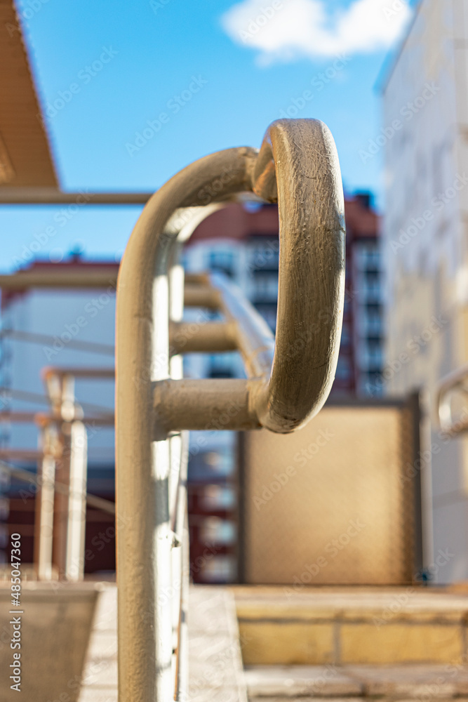 Stairway with metallic banister in a new modern building. Railing at the entrance to an apartment building. Stairway with metallic banister in a new modern building. Railing at the entrance to an apartment building.