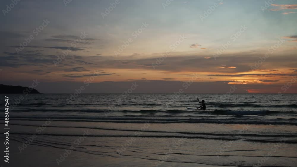 Silhouette of Adult Person Kayaking in Sea at Sunset Silhouette of Adult Person Kayaking in Sea at Sunset