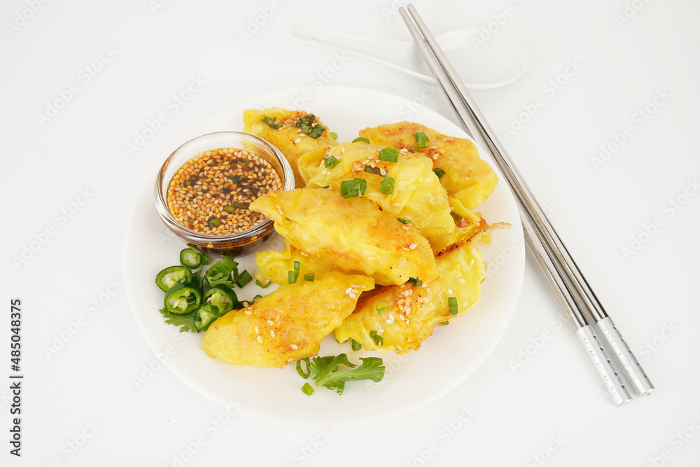 Crispy dumplings and sauces on white background Crispy dumplings and sauces on white background