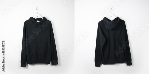 Clothes on a hanger. White wall background. 