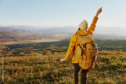 woman mountain top nature travel adventure sunny day