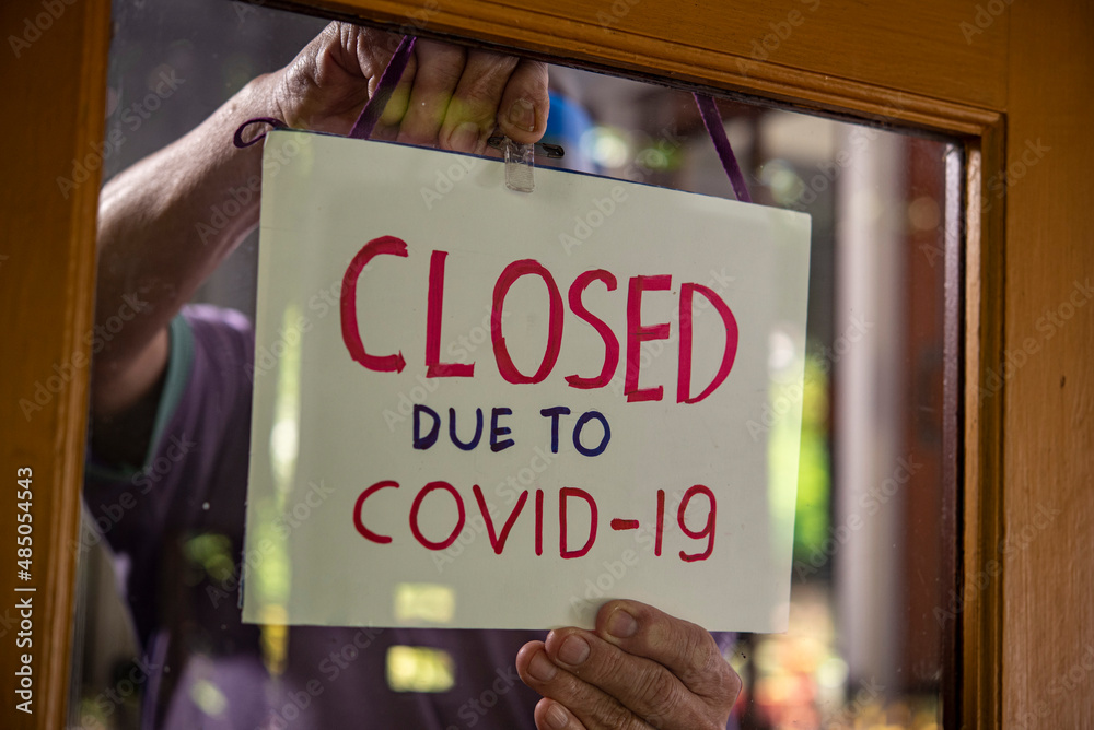 temporary closed sign for covid-19 on shop window