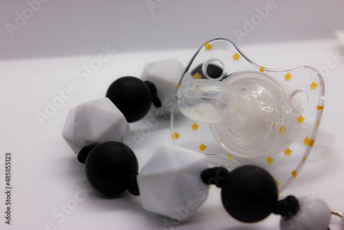 black baby pacifier on a white background