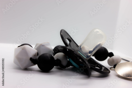 black baby pacifier on a white background