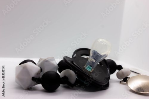 black baby pacifier on a white background