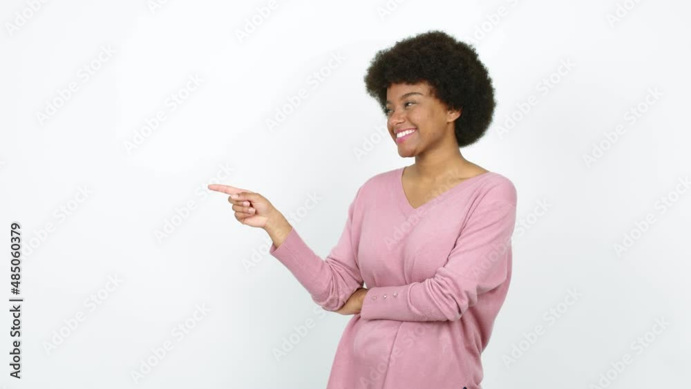 Young African American woman pointing finger to the side and presenting a product over isolated background Young African American woman pointing finger to the side and presenting a product over isolated background