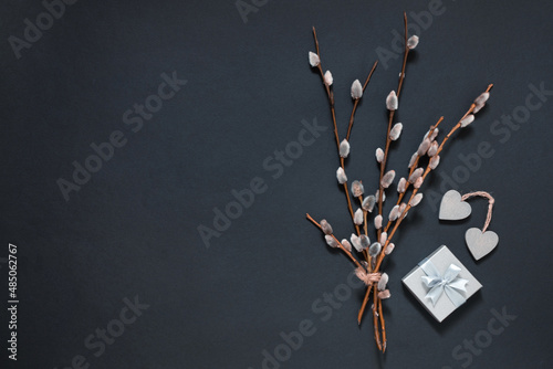 willow twigs with blossoming buds early spring gift box with hearts on black, happy easter, women's day, springtime minimal background