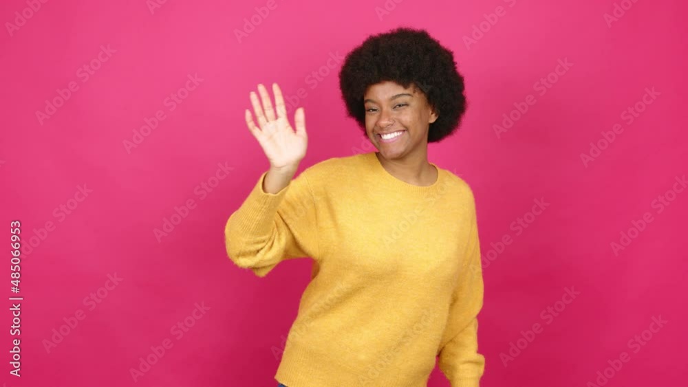 Young African American woman saluting with hand with happy expression over isolated background Young African American woman saluting with hand with happy expression over isolated background