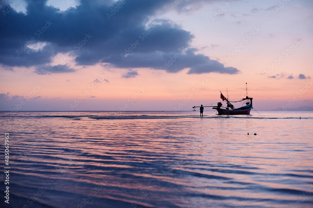 Beautiful tropical sunset. Seascape with purple sky and longtail boats. Samui Island, Thailnd.