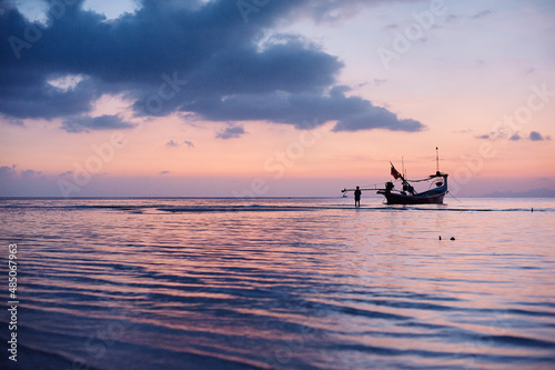 Beautiful tropical sunset. Seascape with purple sky and longtail boats. Samui Island, Thailnd. photo