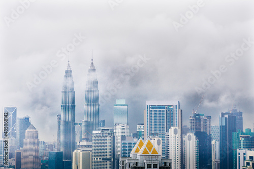Cityscape with cloudy sky and scyscrapers. Megapolis Kuala-Lumpur, Malaysia. 