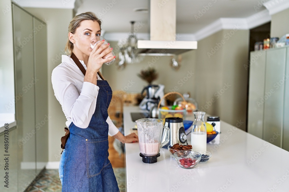 Young blonde woman smiling confident drinking smoothie at kitchen Young blonde woman smiling confident drinking smoothie at kitchen