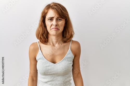 Beautiful caucasian woman standing over isolated background depressed and worry for distress, crying angry and afraid. sad expression.