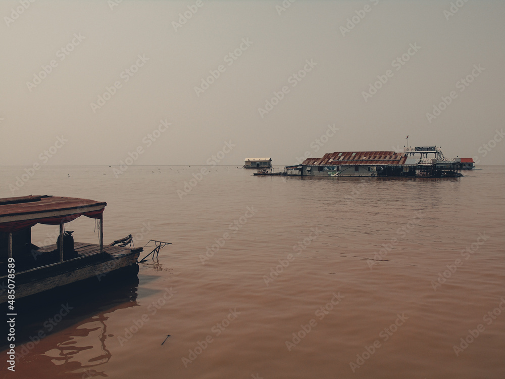 Floating village and boat on Tonlé Sap lake in Cambodia