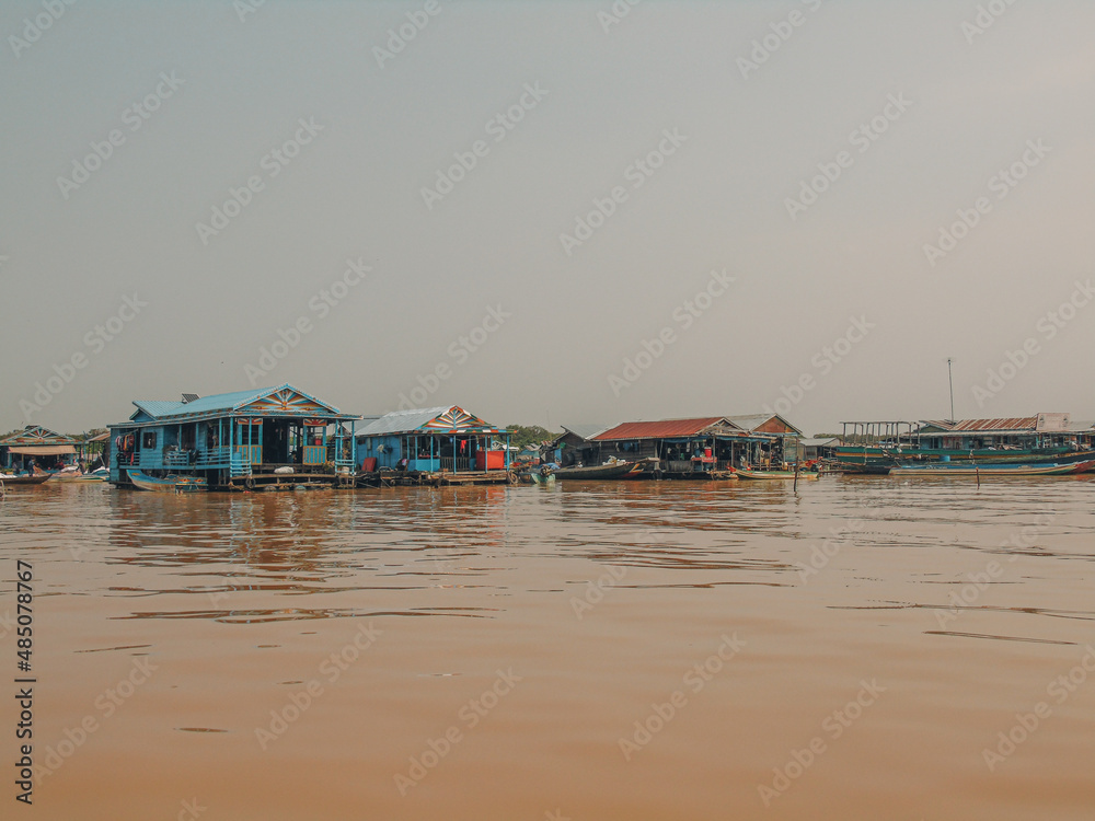 Floating village and boat on Tonlé Sap lake in Cambodia Floating village and boat on Tonlé Sap lake in Cambodia