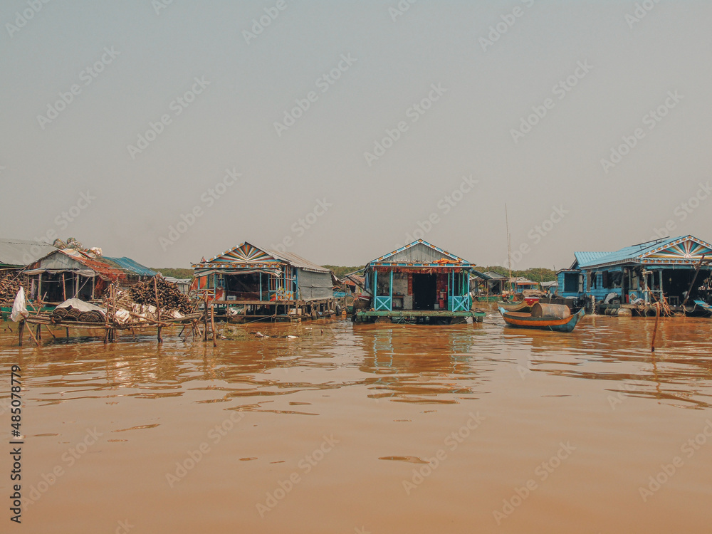 Floating village and boat on Tonlé Sap lake in Cambodia