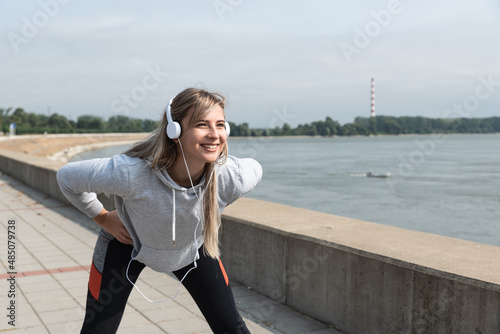 Young active sporty business woman morning routine of stretching and running exercising outdoor before she go to the work at office. Self loved female fitness workout training for healthy life.