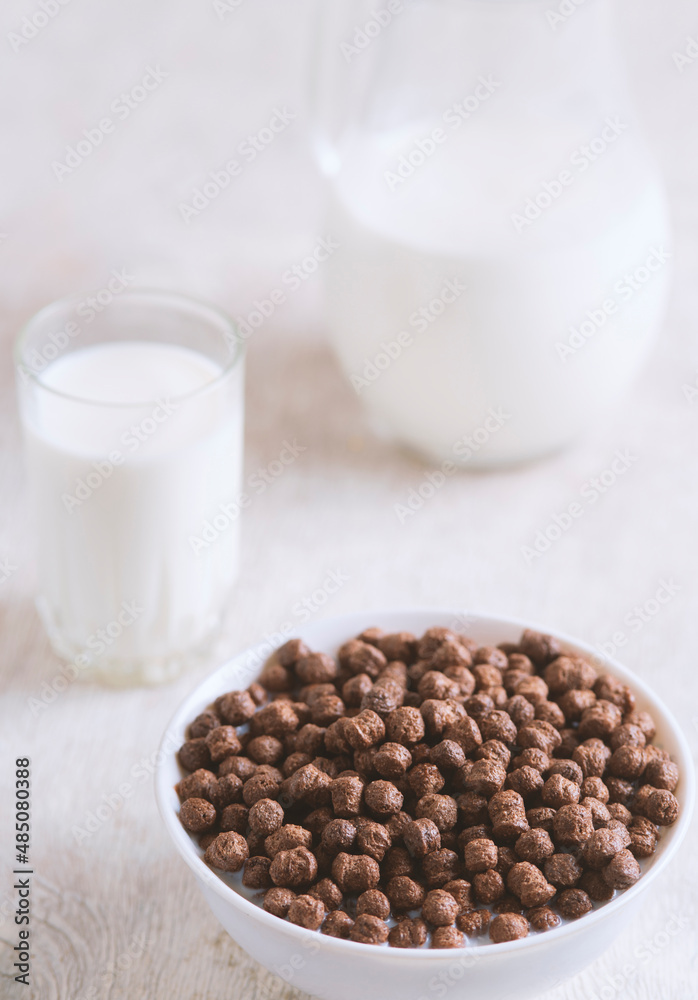 Breakfast: chocolate balls, fresh cows milk, selective focus Breakfast: chocolate balls, fresh cows milk, selective focus