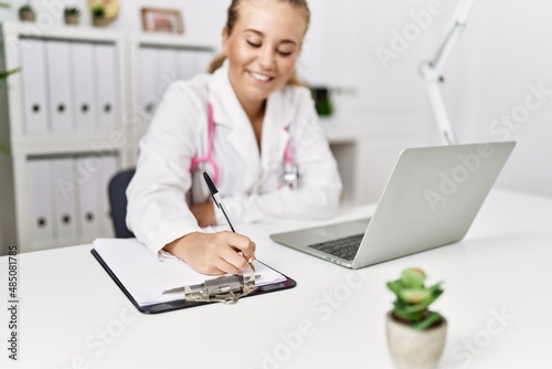 Young blonde girl wearing doctor uniform working at clinic