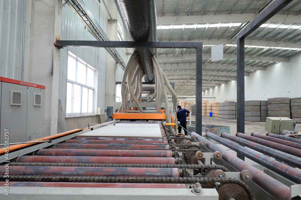 workers operate the distributor on the calcium silicate board production line, North China
