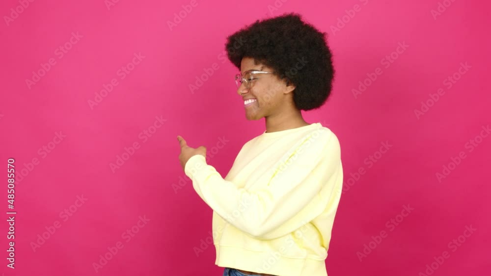 Young African American woman with glasses and presenting something Young African American woman with glasses and presenting something