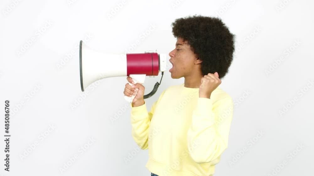 Young African American woman holding a megaphone and shouting over isolated background Young African American woman holding a megaphone and shouting over isolated background