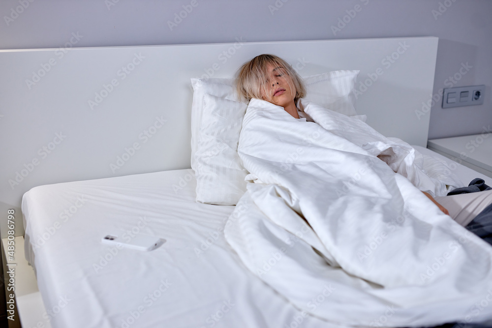 Relaxed Caucasian Female Lying On Bed After Sleeping, Early wake up, not getting enough sleep, getting work concept. In Light interior bedroom at home. Lifestyle, resting, bedtime concept Relaxed Caucasian Female Lying On Bed After Sleeping, Early wake up, not getting enough sleep, getting work concept. In Light interior bedroom at home. Lifestyle, resting, bedtime concept
