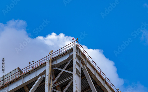 Technological structures of an industrial enterprise against the background of a bright sky and beautiful clouds
