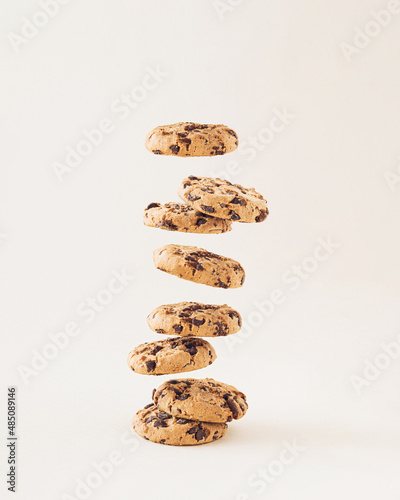 Chocolate chip cookies on the cream background. Sweet food biscuit concept.