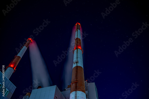 Fototapeta Naklejka Na Ścianę i Meble -  Night shots of pipes of an industrial enterprise against the background of the starry sky
