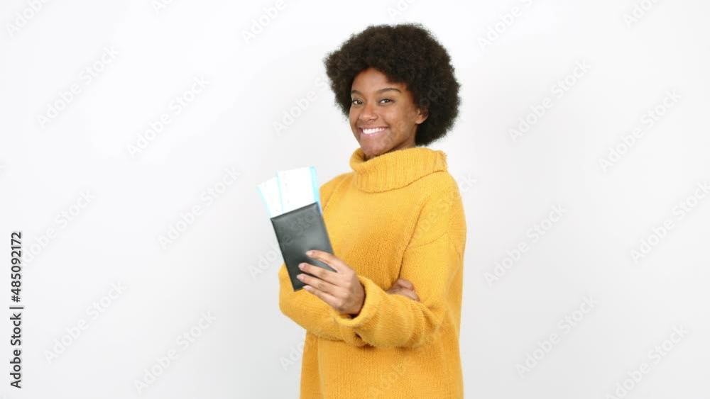 Young African American woman holding a passport over isolated background Young African American woman holding a passport over isolated background