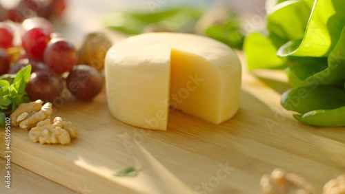 Still life of Cheese served with green, grape and walnut