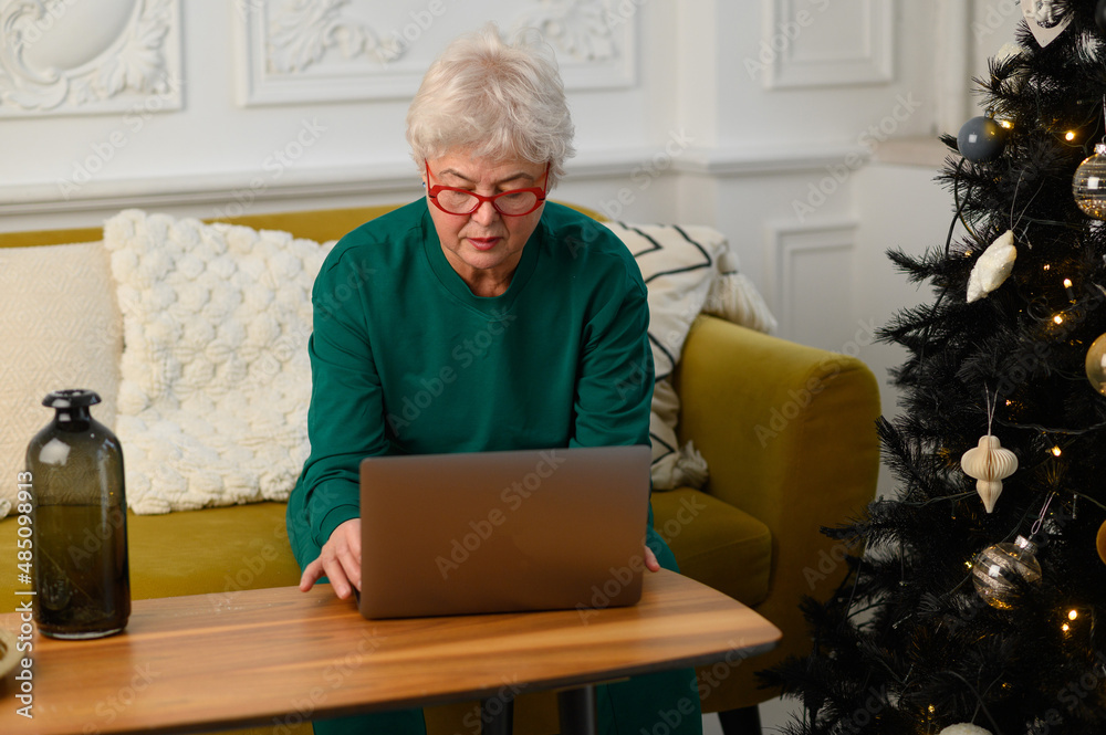 grandma is talking on a video conference with her family. Modern means of communication grandma is talking on a video conference with her family. Modern means of communication