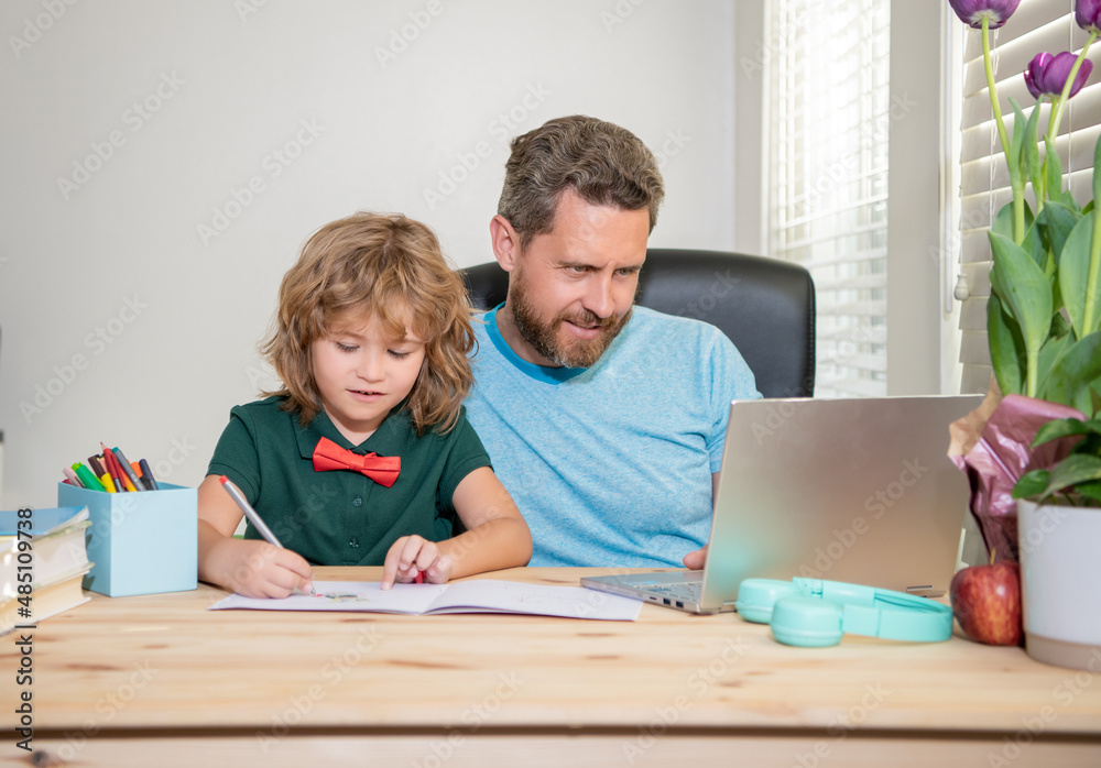 Fototapeta premium bearded dad or school private tutor teaching boy son with modern laptop, lesson online