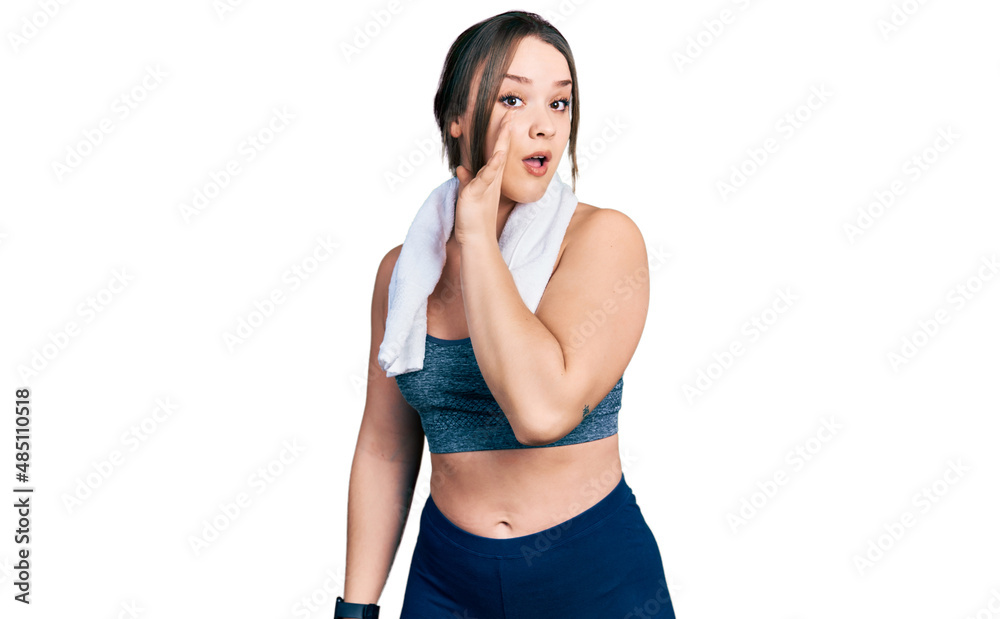 Young hispanic girl wearing sportswear and towel hand on mouth telling secret rumor, whispering malicious talk conversation Young hispanic girl wearing sportswear and towel hand on mouth telling secret rumor, whispering malicious talk conversation
