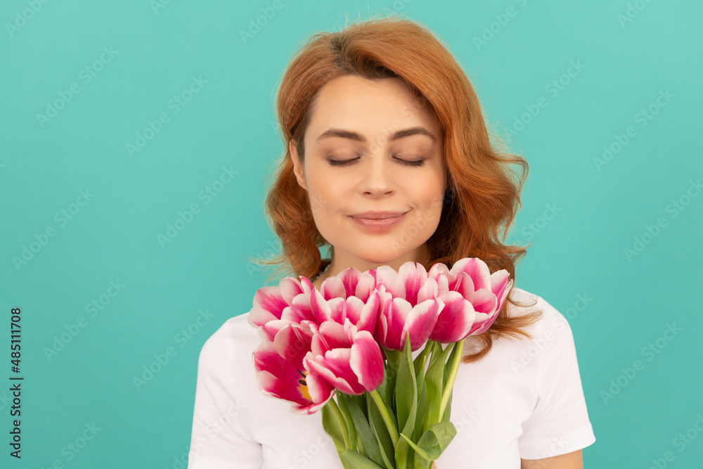 woman smell tulip flower bouquet on blue background woman smell tulip flower bouquet on blue background