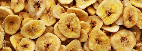 Homemade Banana Chips background, top view.