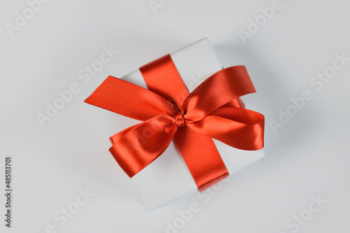 Christmas or any holidays mock up Gift box wrapped in paper and with red bow isolated on white background