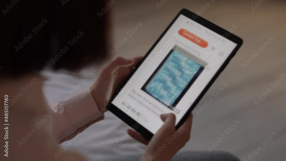 Modern online shop on tablet display in young caucasian woman hands looking to buy a toy for her baby. E-commerce web site with technology products. Concept of shopping online Modern online shop on tablet display in young caucasian woman hands looking to buy a toy for her baby. E-commerce web site with technology products. Concept of shopping online