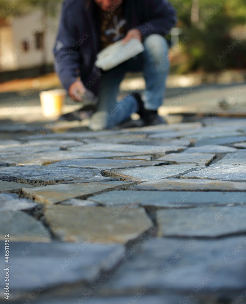 Parent build by worker visible in background in soft focus Parent build by worker visible in background in soft focus