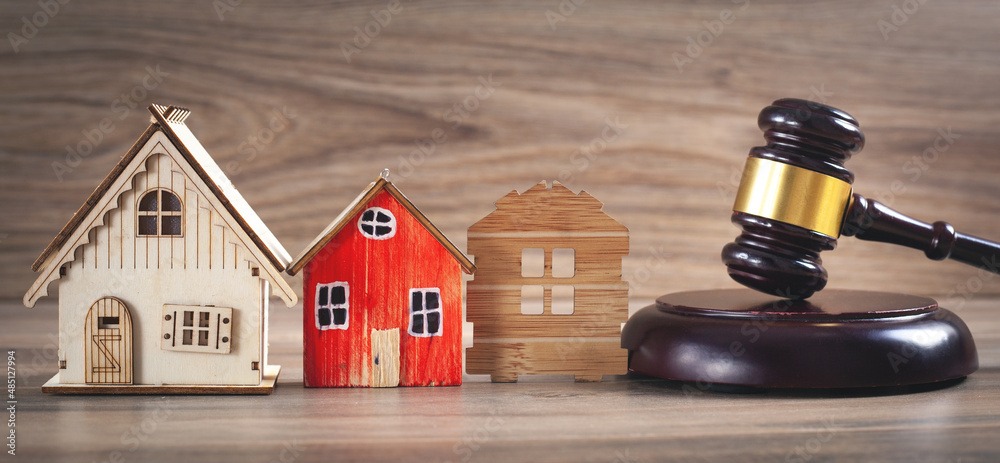 House models with a judge gavel. House models with a judge gavel.