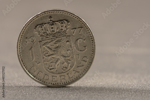 Front side of a former 1 guilder coin from the Netherlands photo