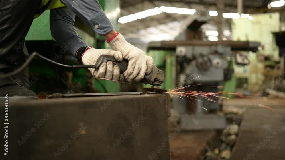Asian technicians work in a mechanical factory. Use a steel grinder to build old machine parts. Asian technicians work in a mechanical factory. Use a steel grinder to build old machine parts.