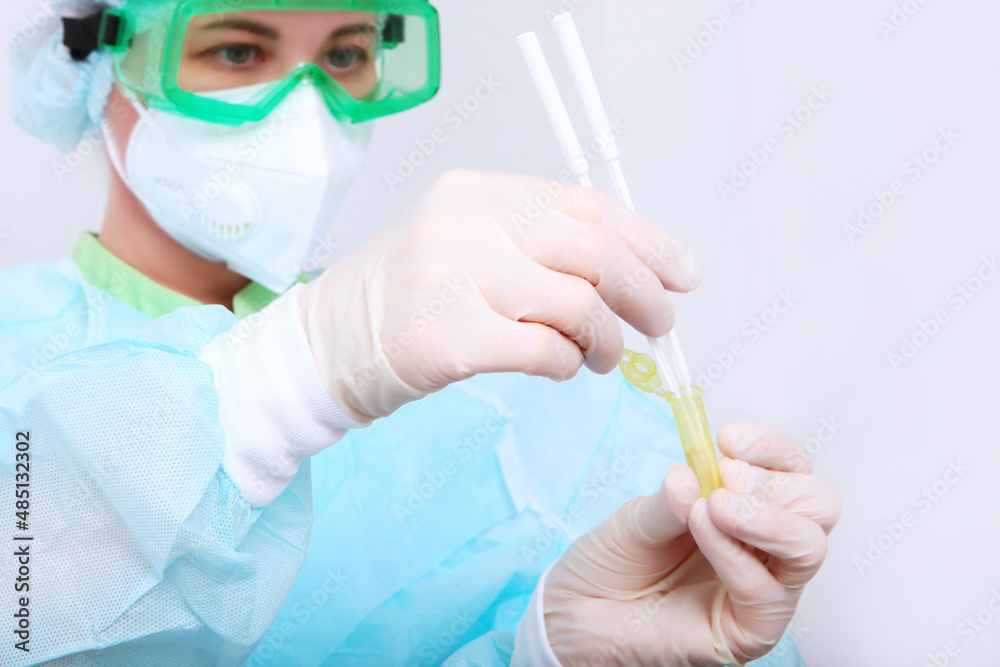 A nurse in a protective mask does a PCR test for covid-19. PCR test for covid-19. Clinical laboratory. High-precision diagnostics. The nurse's face is out of focus. A nurse in a protective mask does a PCR test for covid-19. PCR test for covid-19. Clinical laboratory. High-precision diagnostics. The nurse's face is out of focus.